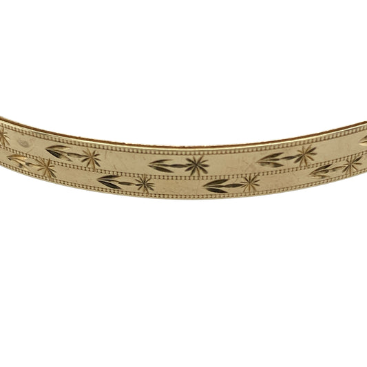 Add timeless elegance to your jewellery collection with this pre-owned 9ct yellow solid gold patterned bangle, featuring classic decorative detailing and a refined polished finish—perfect for everyday wear, occasion styling, or stacking with other gold jewellery pieces.

Design: The bangle features an attractive patterned finish throughout, creating a stylish textured appearance with timeless appeal. Measuring approximately 6mm wide, the design offers a refined yet noticeable presence on the wrist.