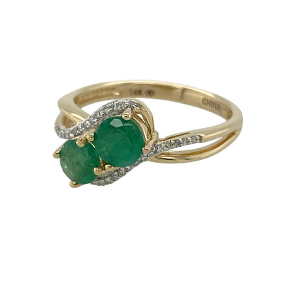 Add timeless elegance and vibrant colour to your jewellery collection with this pre-owned 14ct yellow gold diamond and emerald twist ring, featuring a graceful flowing design with classic gemstone appeal—perfect for special occasions, meaningful gifting, or sophisticated everyday wear.

Design: The ring features a stylish twist design set with round emerald stones, each measuring approximately 5mm in diameter, complemented by sparkling diamond accents for added brilliance and elegance.