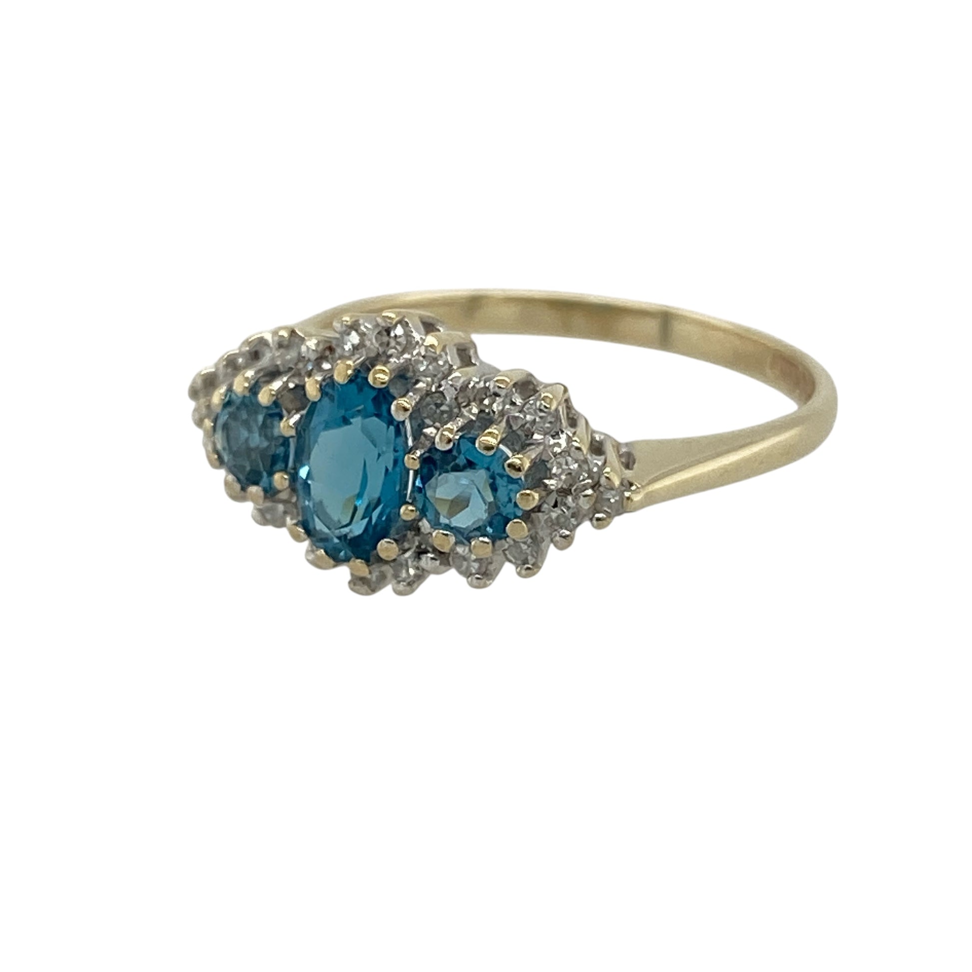 Add elegant sparkle and vibrant colour to your jewellery collection with this pre-owned 9ct yellow gold diamond and blue topaz cluster trilogy ring, featuring a striking multi-stone design with timeless sophistication—perfect for special occasions, gifting, or glamorous everyday wear.

Design: The ring showcases an oval blue topaz centre stone measuring approximately 6mm by 4mm, flanked by two round blue topaz stones measuring approximately 3mm each.