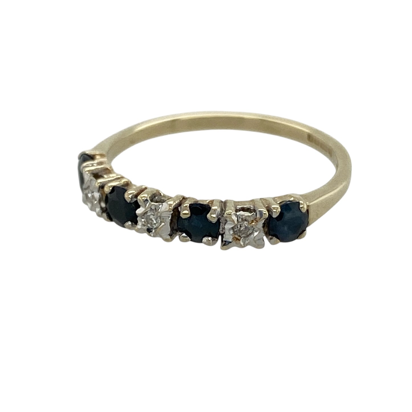 Add timeless elegance and rich colour to your jewellery collection with this pre-owned 9ct yellow gold diamond and sapphire band ring, featuring a classic gemstone design with delicate sparkle—perfect for everyday wear, stacking, or special occasions.

Design: The ring features a row of vibrant sapphire stones, each measuring approximately 3mm in diameter, complemented by sparkling diamond accents for a refined and elegant look.