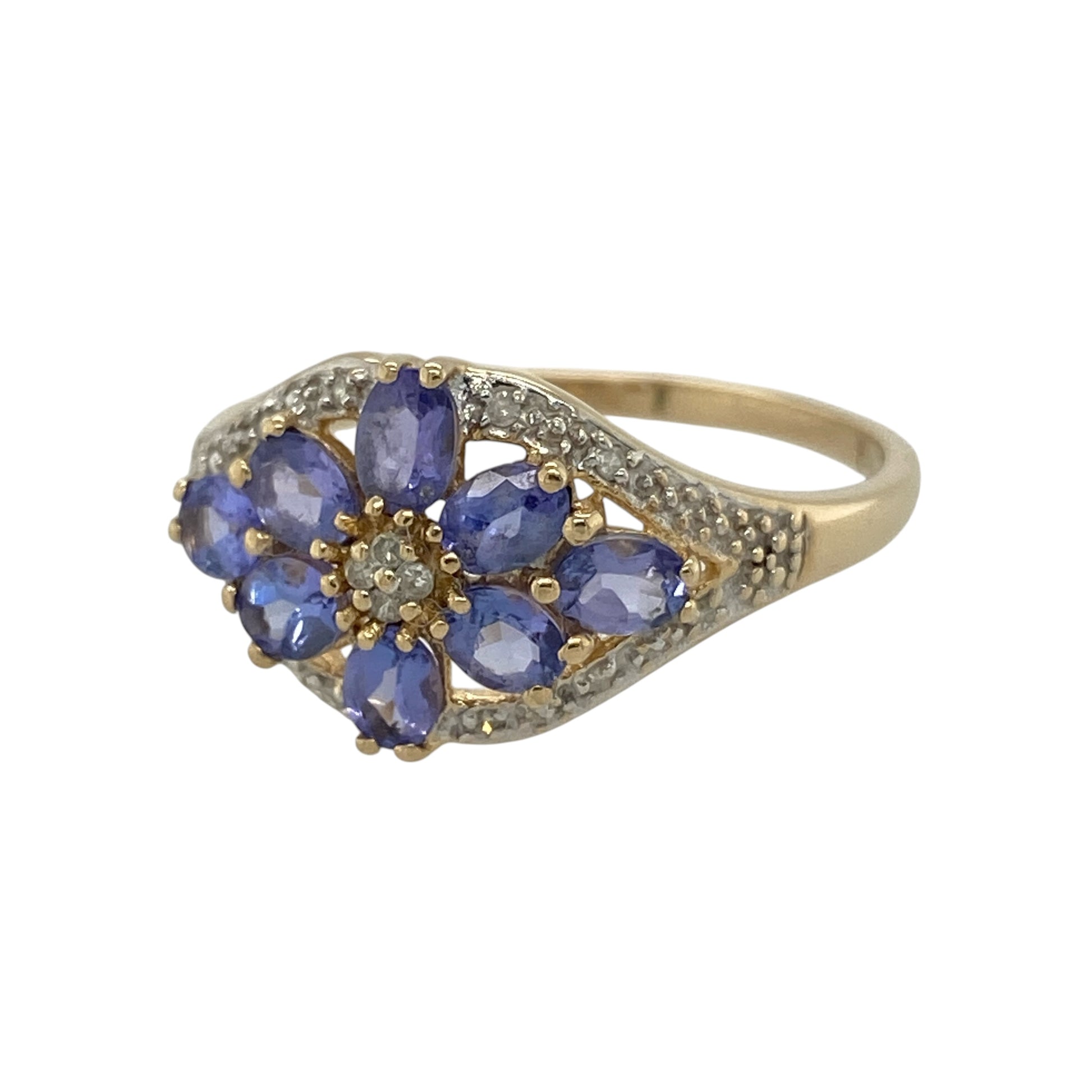 Add vibrant colour and elegant sparkle to your jewellery collection with this pre-owned 14ct yellow gold diamond and tanzanite flower cluster ring, featuring a striking floral-inspired design with timeless sophistication—perfect for special occasions, statement styling, or luxurious everyday wear.

Design: The ring features a beautiful flower cluster arrangement of vibrant tanzanite stones accented with sparkling diamonds, creating an elegant and eye-catching design.