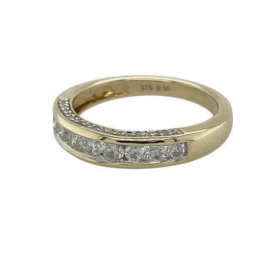 Add timeless sparkle and elegant simplicity to your jewellery collection with this pre-owned 9ct yellow gold diamond set band ring, featuring a classic polished design with versatile everyday appeal—perfect for stacking, special occasions, or sophisticated daily wear.

Design: The ring features a refined band design accented with sparkling diamonds across the front, creating a clean and elegant look. The front of the band measures approximately 4mm wide for a noticeable yet timeless appearance.