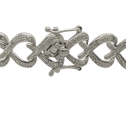 Add romantic elegance and luxurious sparkle to your jewellery collection with this pre-owned 9ct white gold diamond heart link bracelet, featuring a bold statement design with timeless feminine appeal—perfect for special occasions, gifting, or sophisticated everyday wear.

Design: The bracelet features beautifully detailed heart-shaped links accented with sparkling diamonds, creating an eye-catching and elegant design with timeless charm.