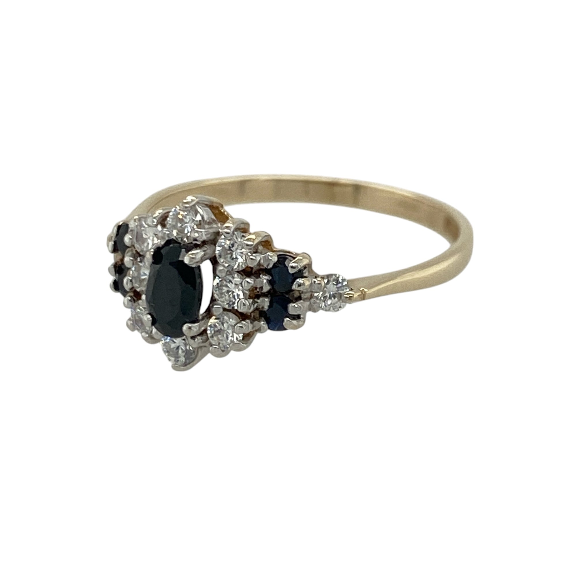 Add timeless elegance and rich colour to your jewellery collection with this pre-owned 9ct yellow gold sapphire and cubic zirconia cluster ring, featuring a classic gemstone design with refined sparkle—perfect for special occasions, gifting, or sophisticated everyday wear.

Design: The ring showcases an elegant oval sapphire centre stone measuring approximately 5mm by 3mm, surrounded by sparkling cubic zirconia stones in a beautiful cluster arrangement.