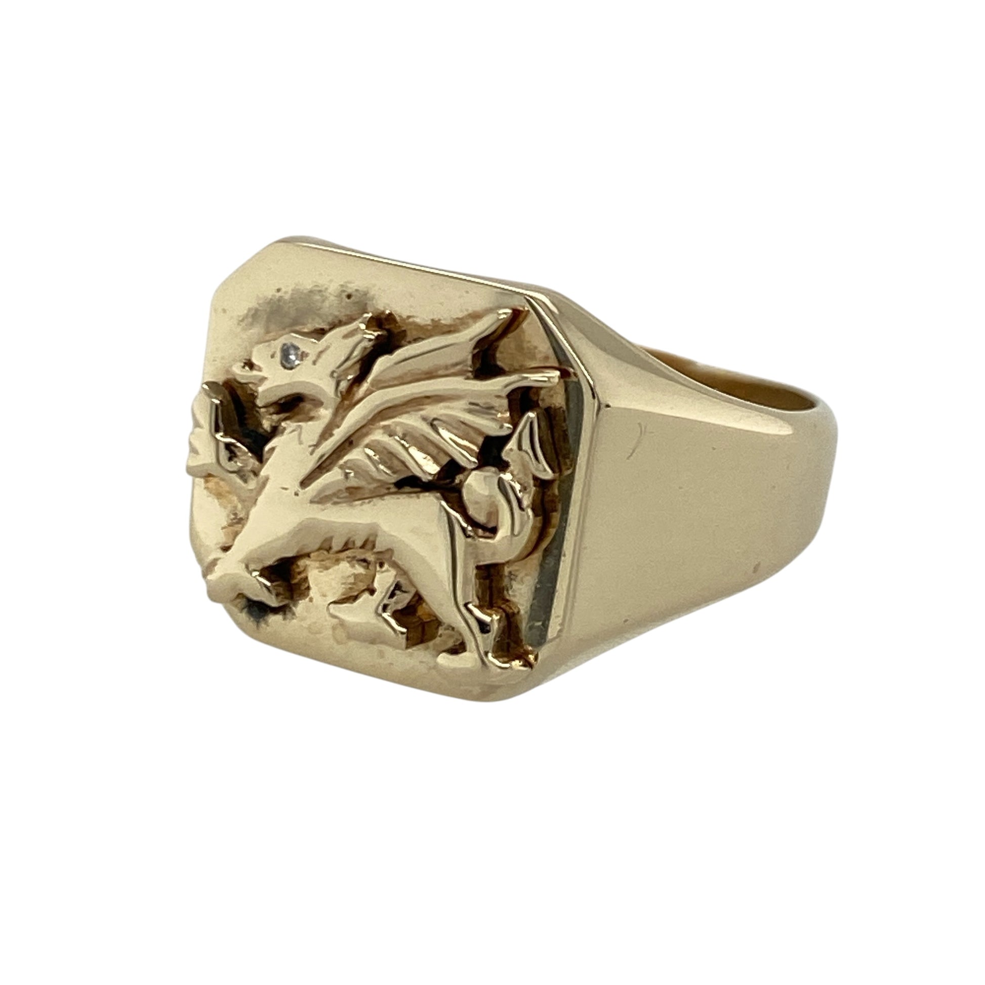 Celebrate Welsh heritage with this pre-owned 9ct yellow gold Welsh Dragon square signet ring, featuring a bold traditional design enhanced with a sparkling diamond detail—perfect for everyday wear, gifting, or adding a meaningful statement piece to your jewellery collection.

Design: The ring showcases a striking square signet front featuring the iconic Welsh Dragon motif, measuring approximately 14mm high for a bold and eye-catching appearance.