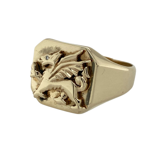 Celebrate Welsh heritage with this pre-owned 9ct yellow gold Welsh Dragon square signet ring, featuring a bold traditional design enhanced with a sparkling diamond detail—perfect for everyday wear, gifting, or adding a meaningful statement piece to your jewellery collection.

Design: The ring showcases a striking square signet front featuring the iconic Welsh Dragon motif, measuring approximately 14mm high for a bold and eye-catching appearance.