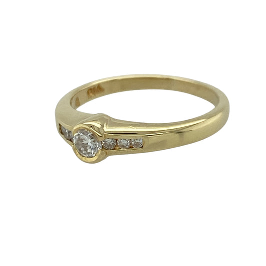 Add timeless elegance and refined sparkle to your jewellery collection with this pre-owned 18ct yellow gold diamond set solitaire ring, featuring a classic centre stone design enhanced with diamond-set shoulders—perfect for engagements, anniversaries, or sophisticated everyday wear.

Design: The ring showcases a sparkling centre diamond complemented by three smaller diamonds set on each side, creating a beautifully balanced and elegant look.