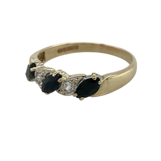 Add timeless elegance and rich colour to your jewellery collection with this pre-owned 9ct yellow gold diamond and sapphire band ring, featuring a classic gemstone design with refined sparkle—perfect for everyday wear, special occasions, or meaningful gifting.

Design: The ring features a row of elegant marquise-cut sapphire stones, each measuring approximately 6mm by 3mm, complemented by sparkling diamond accents to create a beautifully balanced and eye-catching band design.
