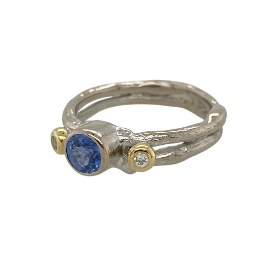 Add timeless elegance and striking contrast to your jewellery collection with this pre-owned 18ct white gold diamond and sapphire double band ring, featuring a sophisticated two-tone design with classic gemstone appeal—perfect for special occasions, anniversaries, or luxurious everyday wear.

Design: The ring showcases a vibrant round sapphire measuring approximately 5mm in diameter, complemented by a sparkling yellow gold set diamond on either side.