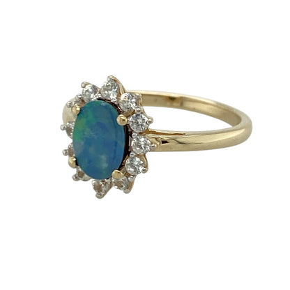 Add vibrant colour and elegant sparkle to your jewellery collection with this pre-owned 9ct yellow gold blue doublet and cubic zirconia cluster ring, featuring a classic gemstone design with eye-catching brilliance—perfect for special occasions, gifting, or sophisticated everyday wear.

Design: The ring showcases a beautiful oval blue doublet stone measuring approximately 7mm by 5mm, surrounded by sparkling cubic zirconia stones in an elegant cluster setting that enhances its colour and brilliance.