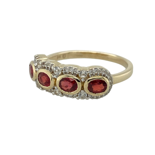 Add rich colour and elegant sparkle to your jewellery collection with this pre-owned 9ct yellow gold red stone and cubic zirconia band ring, featuring a bold gemstone design with timeless everyday appeal—perfect for special occasions, gifting, or statement styling.

Design: The ring features vibrant red stones measuring approximately 4mm by 3mm each, complemented by sparkling cubic zirconia accents across a band measuring approximately 6mm wide at the front.