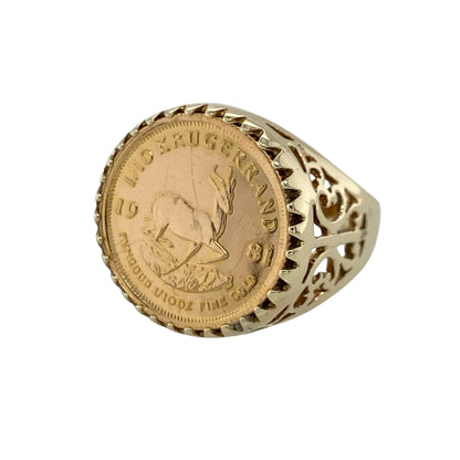 Add investment-inspired style and timeless heritage to your jewellery collection with this pre-owned 9ct yellow gold mount ring featuring a genuine 22ct 1/10 Krugerrand, combining iconic bullion appeal with classic signet ring styling—perfect for collectors, gifting, or statement wear.

Design: The ring showcases a genuine 1981 22ct gold 1/10 Krugerrand mounted within a bold signet-style setting.