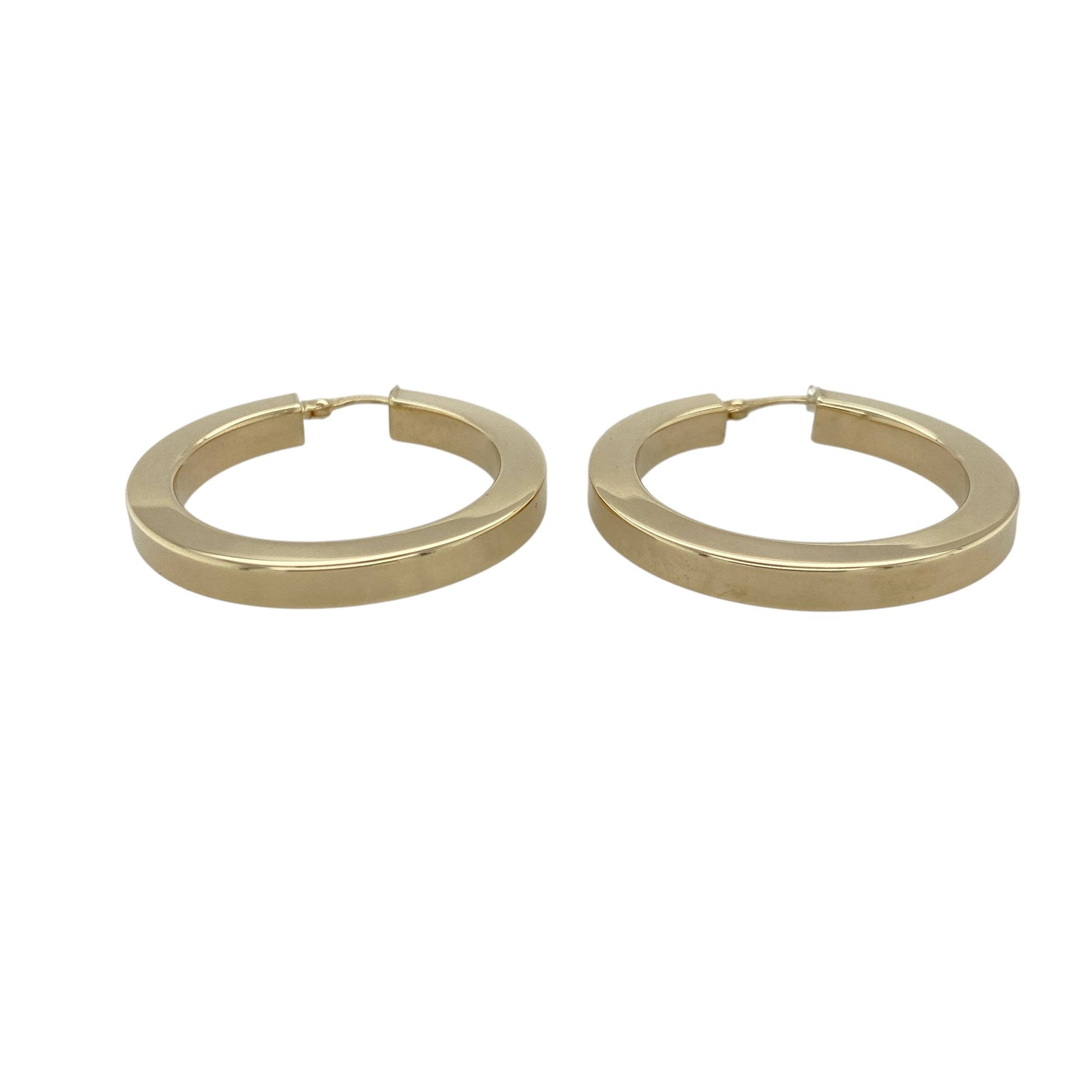 Add bold contemporary style to your jewellery collection with these pre-owned 9ct yellow gold squared plain hoop creole earrings, featuring a striking geometric design with timeless everyday appeal—perfect for statement wear, special occasions, or elevating any outfit.

Design: The earrings feature a distinctive squared hoop creole design with a smooth plain finish, offering a modern take on the classic hoop earring. Measuring approximately 34mm in diameter, they create a bold and eye-catching look.