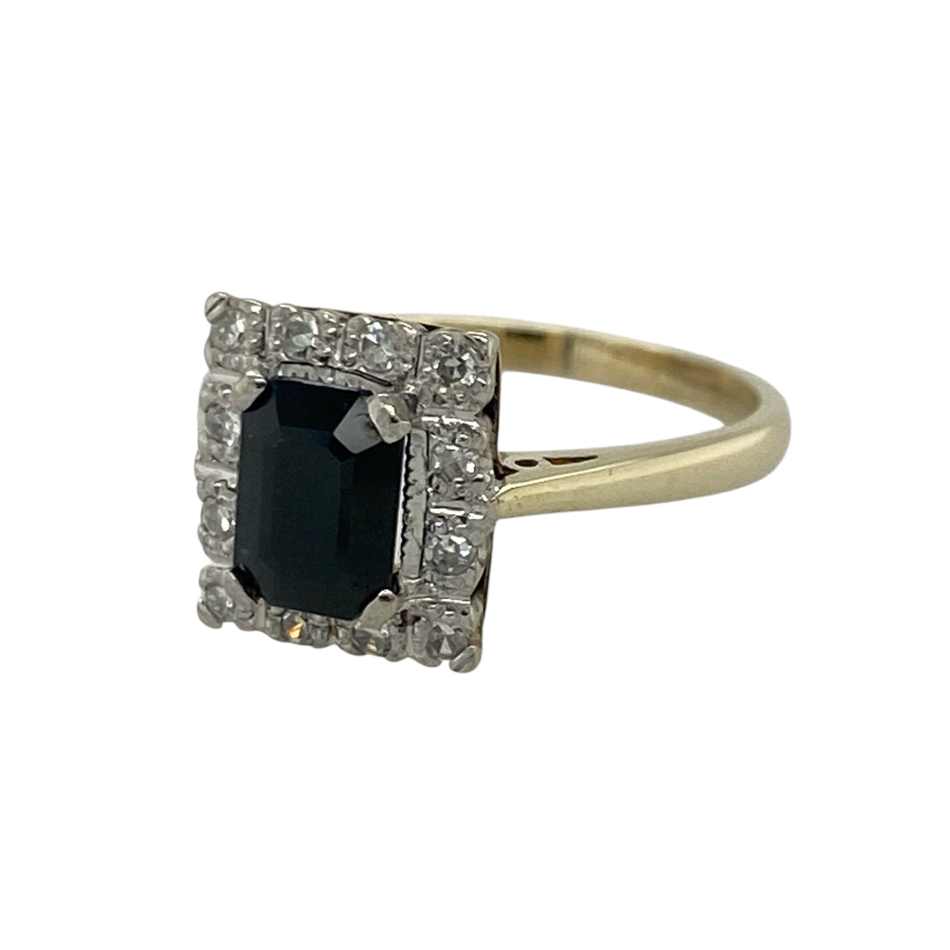 Add timeless elegance and rich colour to your jewellery collection with this pre-owned 9ct yellow gold diamond and sapphire cluster ring, featuring a striking gemstone design with luxurious sparkle and classic appeal—perfect for special occasions, gifting, or sophisticated everyday wear.

Design: The ring showcases a beautiful rectangular sapphire centre stone measuring approximately 7mm by 5mm, surrounded by sparkling diamonds in an elegant cluster setting.