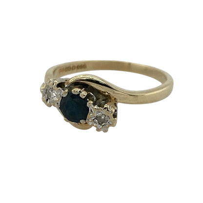 Add timeless elegance and classic sparkle to your jewellery collection with this pre-owned 9ct yellow gold diamond and sapphire trilogy twist ring, featuring a graceful three-stone design with sophisticated everyday appeal—perfect for special occasions, gifting, or refined daily wear.

Design: The ring showcases a beautiful round sapphire centre stone measuring approximately 4mm in diameter, complemented by sparkling diamonds on either side in a classic trilogy arrangement.