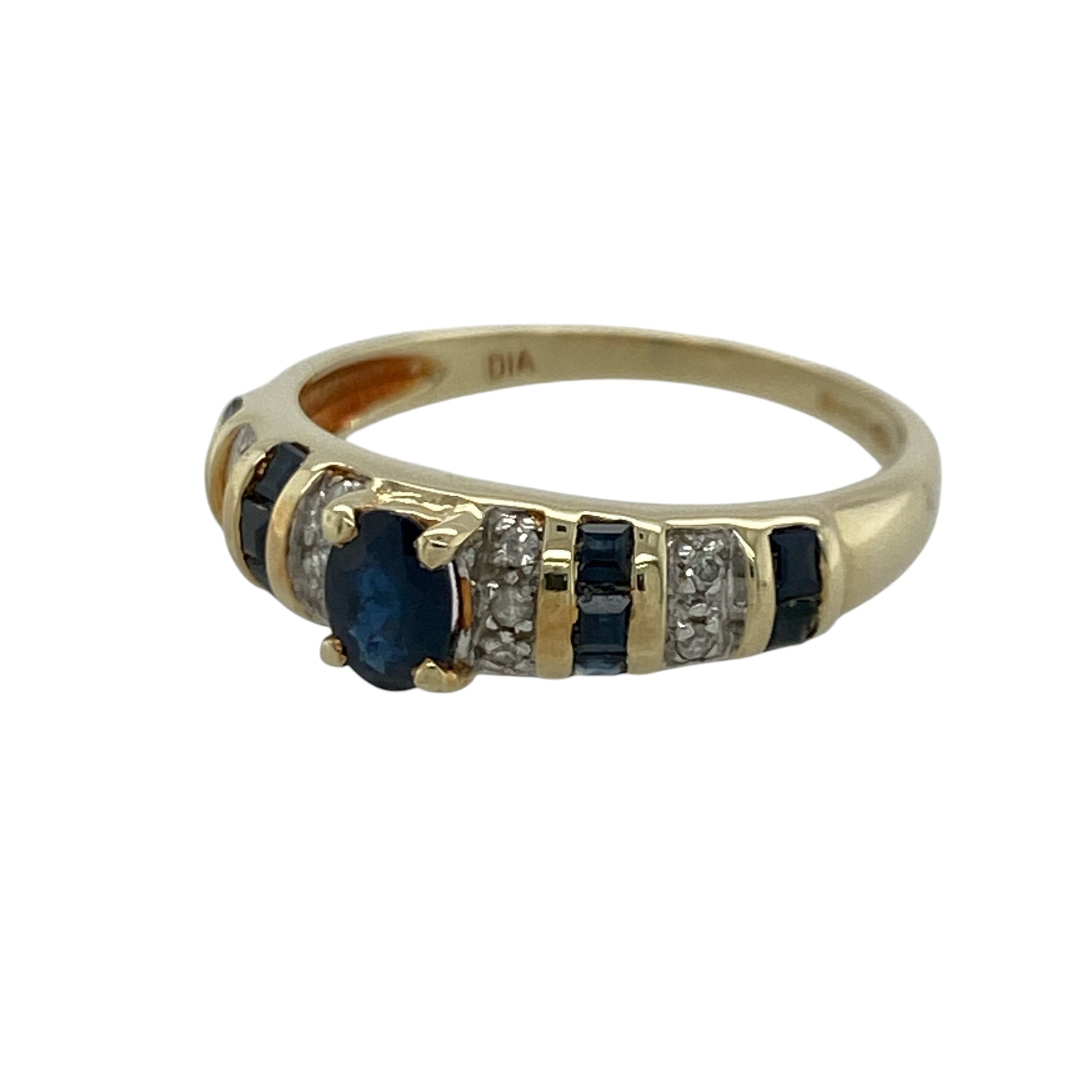 Add timeless elegance and rich colour to your jewellery collection with this pre-owned 14ct yellow gold diamond and sapphire band ring, featuring a classic gemstone design with refined sparkle and everyday sophistication—perfect for special occasions, gifting, or elegant daily wear.

Design: The ring showcases a beautiful oval sapphire centre stone measuring approximately 5mm by 4mm, complemented by additional sapphires and sparkling diamonds set along the band.