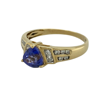 Add vibrant colour and timeless elegance to your jewellery collection with this pre-owned 18ct yellow gold diamond and tanzanite ring, featuring a distinctive gemstone cut with luxurious sparkle and sophisticated appeal—perfect for special occasions, gifting, or refined everyday wear.

Design: The ring showcases a beautiful triangular-cut tanzanite stone measuring approximately 6mm by 6mm by 6mm, creating a unique and eye-catching focal point.