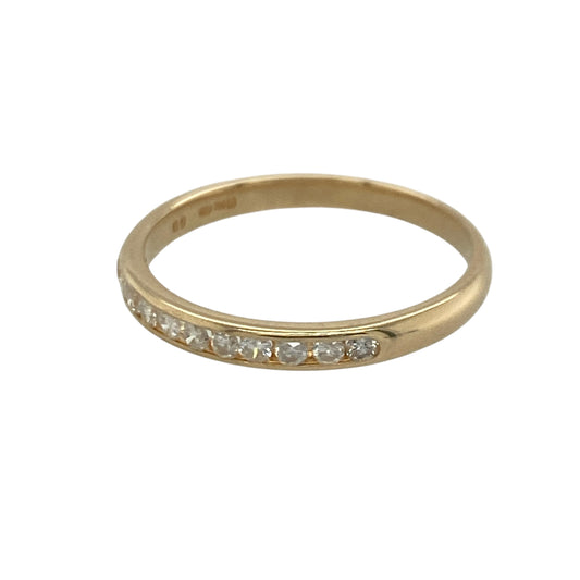 Add timeless sparkle and understated elegance to your jewellery collection with this pre-owned 9ct yellow gold diamond band ring, featuring a sleek channel-set design with refined everyday appeal—perfect for stacking, anniversaries, or sophisticated daily wear.

Design: The ring features a slender 2mm wide band set with sparkling channel-set diamonds, creating a clean and contemporary look with approximately 0.20ct of total diamond content.