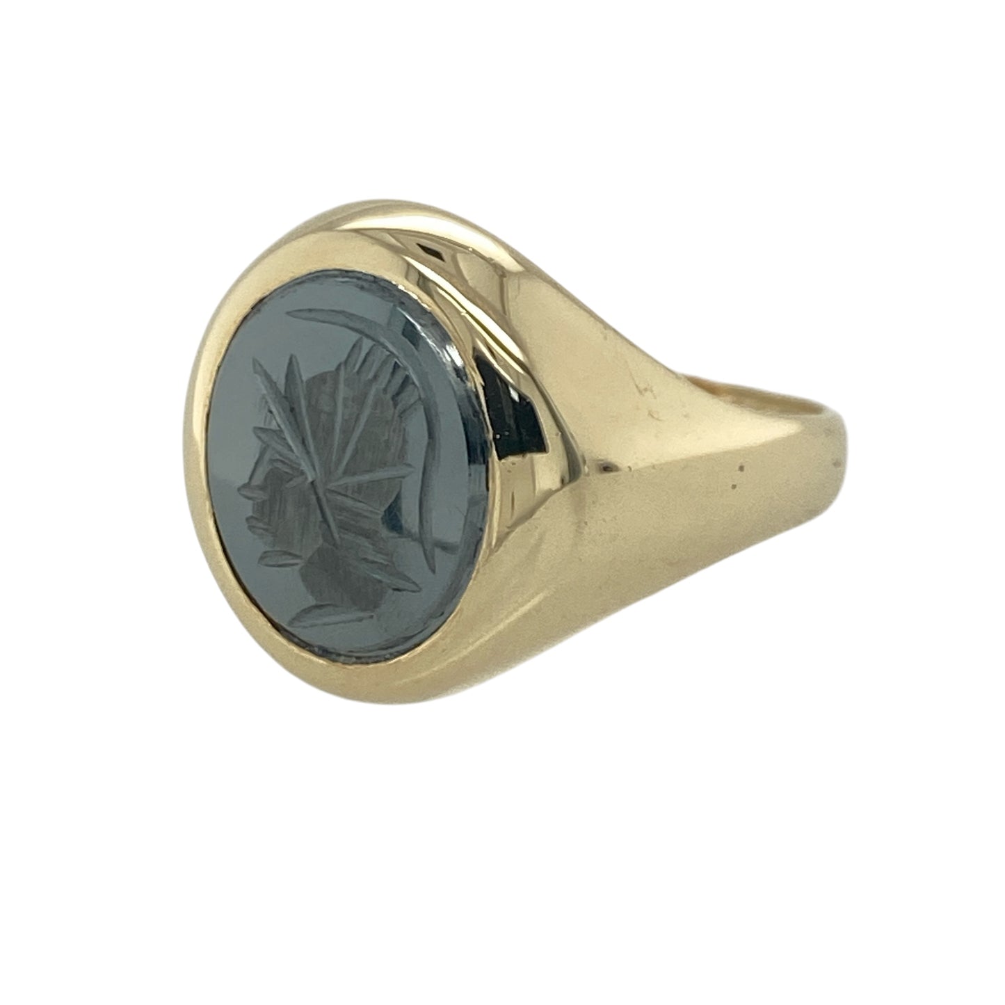 Add timeless character and heritage-inspired style to your jewellery collection with this pre-owned 9ct yellow gold hematite Centurion oval signet ring, featuring a detailed classical design with bold everyday appeal—perfect for collectors, gifting, or statement wear.

Design: The ring showcases a polished oval hematite stone measuring approximately 12mm by 10mm, engraved with a traditional Centurion motif that creates a striking and distinctive focal point.