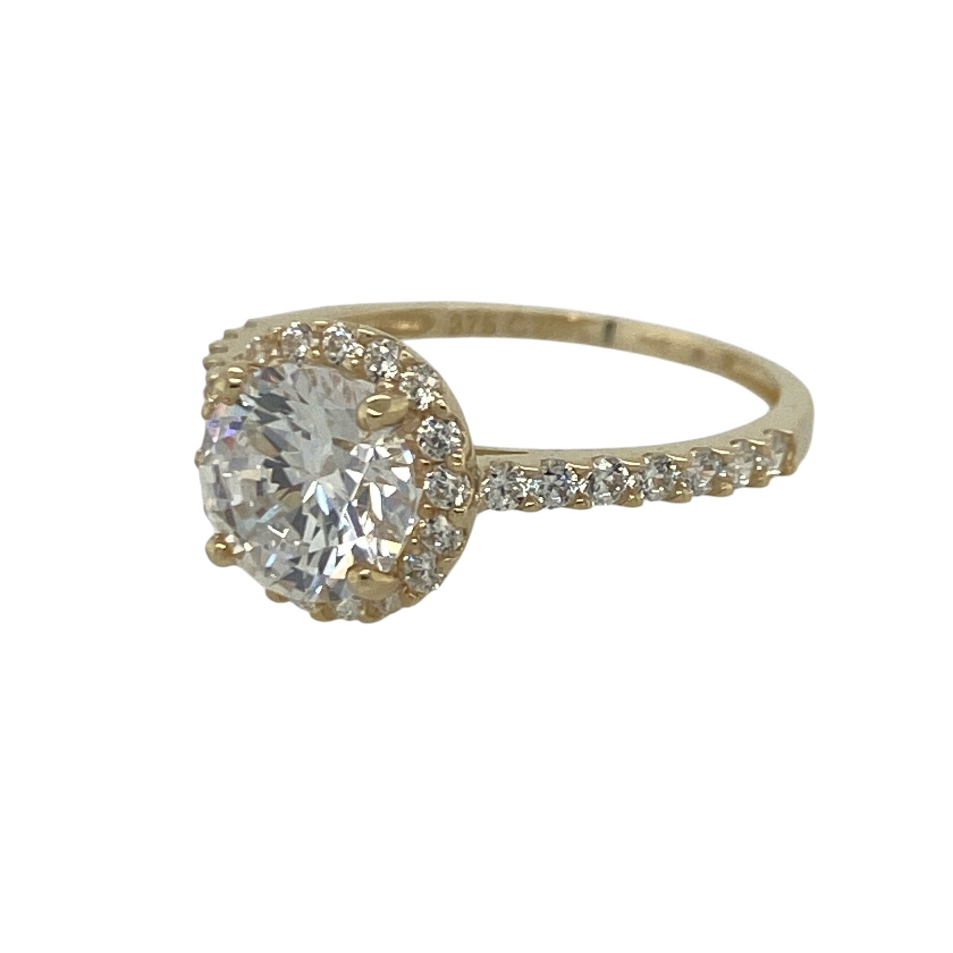 Add dazzling sparkle and timeless elegance to your jewellery collection with this pre-owned 9ct yellow gold cubic zirconia halo cluster ring, featuring a classic halo design with stone-set shoulders for maximum brilliance—perfect for special occasions, gifting, or glamorous everyday wear.

Design: The ring showcases a sparkling round centre stone measuring approximately 7mm in diameter, surrounded by a halo of cubic zirconia stones measuring approximately 9mm in diameter overall.