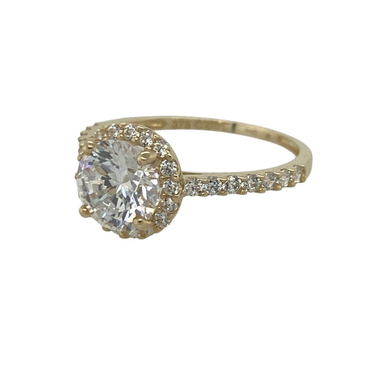 Add dazzling sparkle and timeless elegance to your jewellery collection with this pre-owned 9ct yellow gold cubic zirconia halo cluster ring, featuring a classic halo design with stone-set shoulders for maximum brilliance—perfect for special occasions, gifting, or glamorous everyday wear.

Design: The ring showcases a sparkling round centre stone measuring approximately 7mm in diameter, surrounded by a halo of cubic zirconia stones measuring approximately 9mm in diameter overall.
