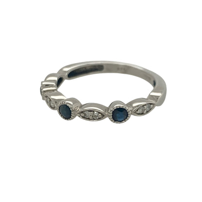Add timeless elegance and rich colour to your jewellery collection with this pre-owned 9ct white gold diamond and sapphire band ring, featuring a classic gemstone design with refined everyday appeal—perfect for special occasions, gifting, or sophisticated daily wear.

Design: The ring features a beautifully balanced arrangement of sparkling diamonds and vibrant sapphires across the front of the band, creating an elegant display of colour and brilliance.
