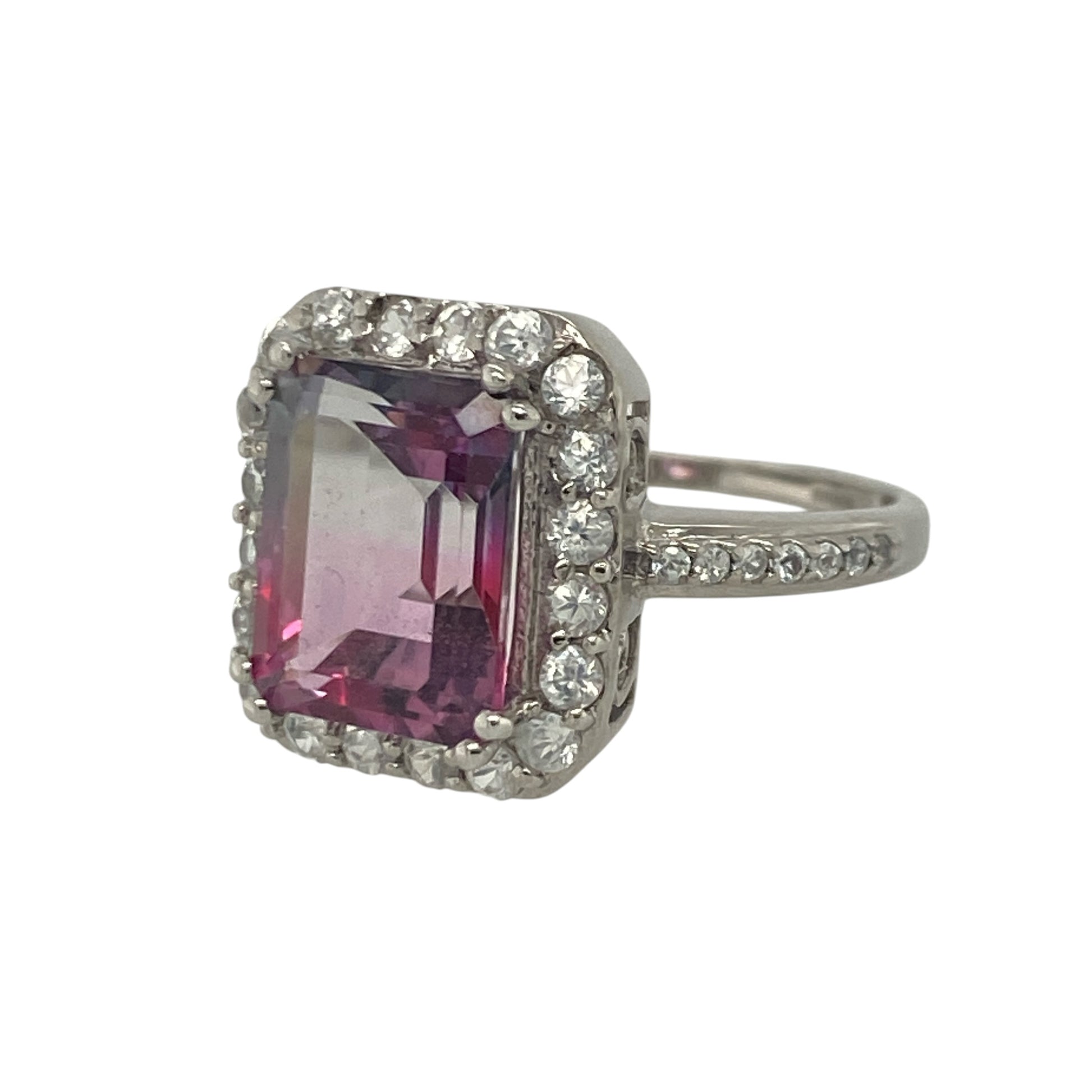 Add vibrant colour and elegant sparkle to your jewellery collection with this pre-owned 9ct white gold pink ametrine and cubic zirconia cluster ring, featuring a striking gemstone design with luxurious everyday appeal—perfect for special occasions, gifting, or statement wear.

Design: The ring showcases a beautiful rectangular pink and purple ametrine stone measuring approximately 10mm by 8mm, creating a bold and eye-catching focal point.