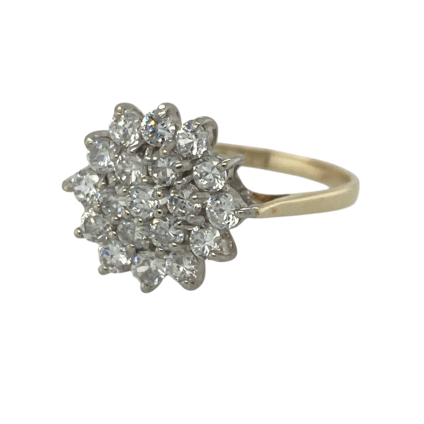 Add dazzling sparkle and timeless elegance to your jewellery collection with this pre-owned 9ct yellow gold cubic zirconia cluster ring, featuring a striking multi-stone design with glamorous everyday appeal—perfect for special occasions, gifting, or statement wear.

Design: The ring showcases an eye-catching cluster arrangement measuring approximately 14mm high at the front, created from numerous sparkling cubic zirconia stones, each measuring approximately 2mm in diameter.
