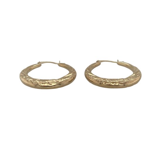 Add timeless elegance and subtle texture to your jewellery collection with these pre-owned 9ct yellow gold patterned hoop creole earrings, featuring a classic design with versatile everyday appeal—perfect for gifting, daily wear, or effortless styling.

Design: The earrings feature a traditional hoop creole design enhanced with attractive patterned detailing that catches the light beautifully. The textured finish adds extra character and sparkle while maintaining the timeless appeal of classic gold hoops.