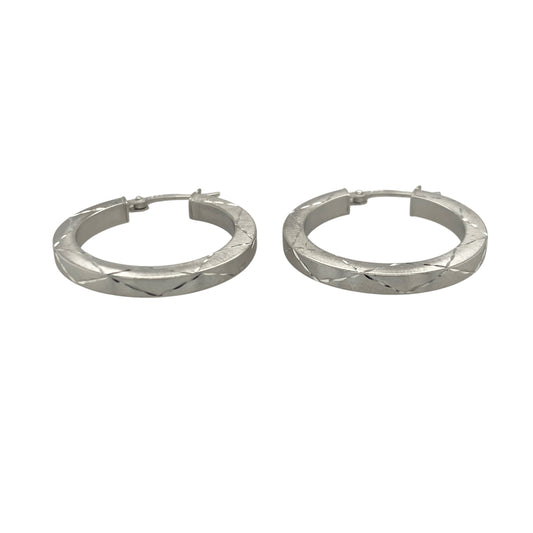 Add contemporary elegance to your jewellery collection with these pre-owned 9ct white gold criss-cross patterned hoop creole earrings, featuring a stylish textured finish with versatile everyday appeal—perfect for gifting, daily wear, or sophisticated occasion styling.

Design: The earrings feature a classic hoop creole design enhanced with an attractive criss-cross pattern and brushed effect finish.