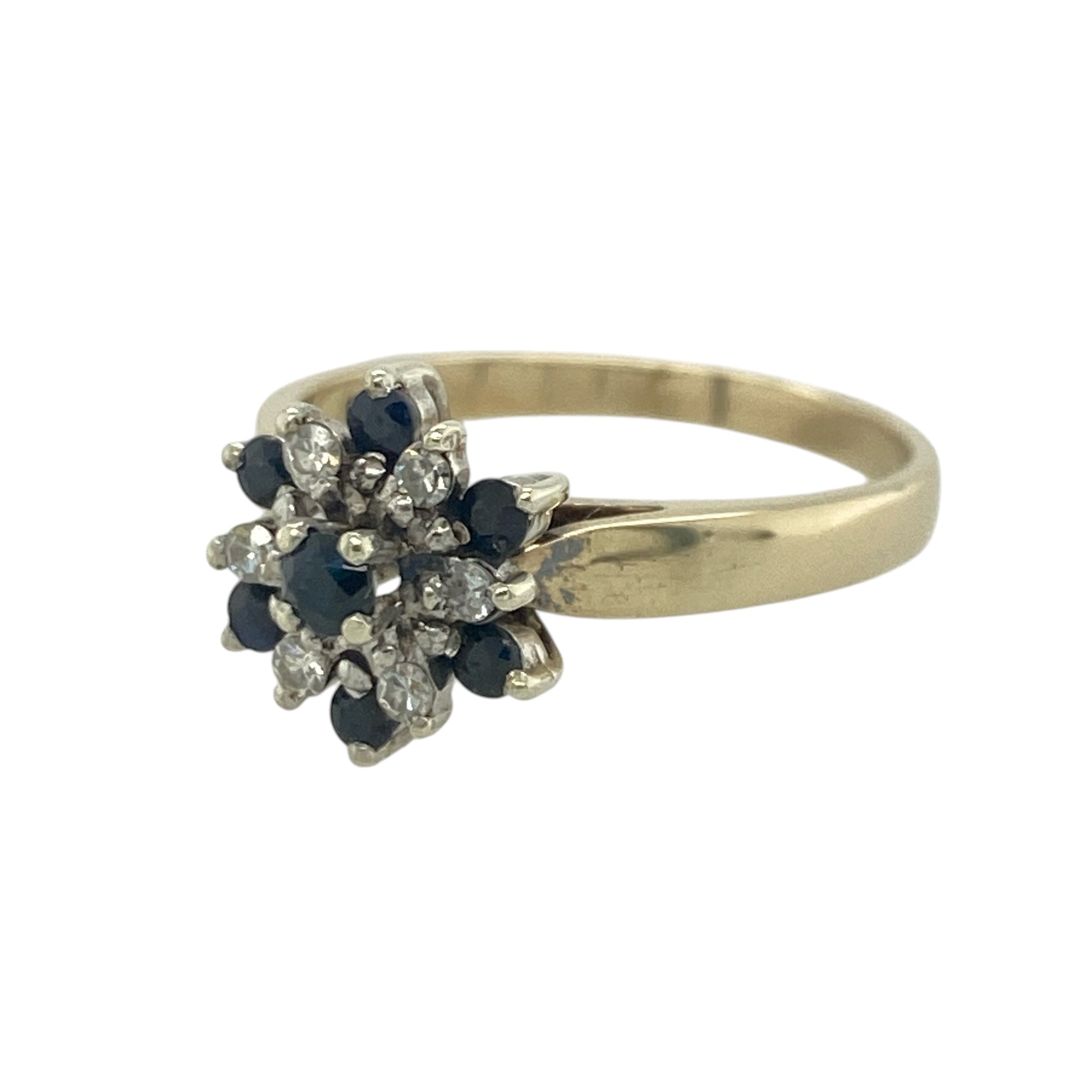 Add timeless elegance and rich colour to your jewellery collection with this pre-owned 9ct yellow gold diamond and sapphire flower cluster ring, featuring a beautiful floral-inspired design with classic everyday appeal—perfect for special occasions, gifting, or refined daily wear.

Design: The ring showcases a striking flower cluster design measuring approximately 11mm high at the front, combining vibrant sapphires and sparkling diamonds to create a beautifully balanced floral display.