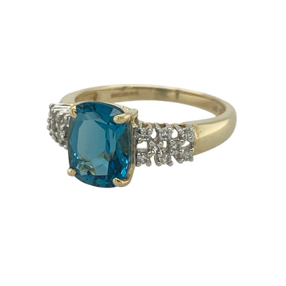 Add vibrant colour and elegant sparkle to your jewellery collection with this pre-owned 9ct yellow gold diamond and blue topaz ring, featuring a classic gemstone design with sophisticated everyday appeal—perfect for special occasions, gifting, or refined daily wear.

Design: The ring showcases a beautiful oval blue topaz measuring approximately 9mm by 7mm, creating a striking focal point with its captivating sky-blue colour.