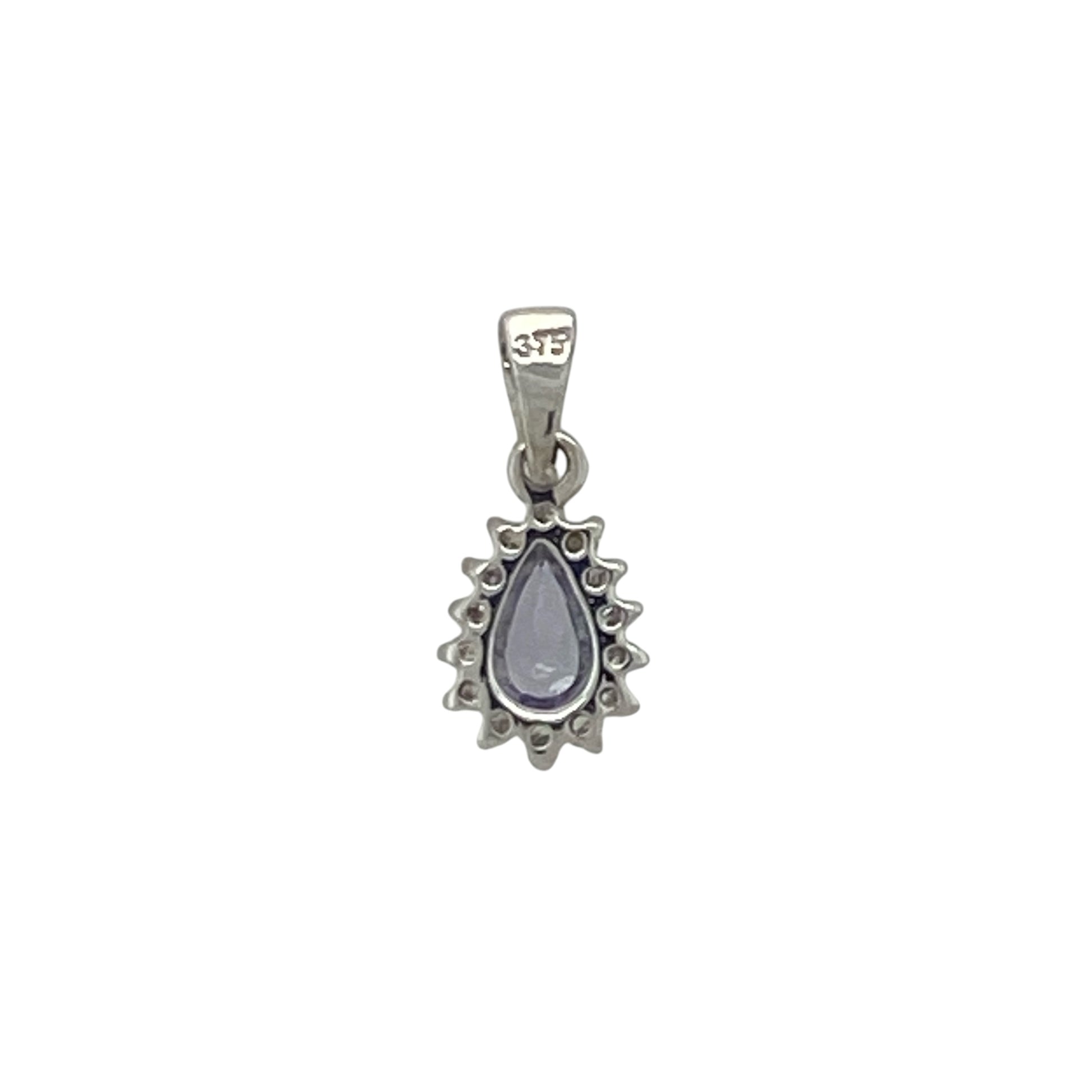 Add a touch of elegant colour and sparkle to your jewellery collection with this pre-owned 9ct white gold diamond and tanzanite teardrop cluster pendant, featuring a graceful gemstone design with timeless everyday appeal—perfect for gifting, special occasions, or refined daily wear.

Design: The pendant showcases a beautiful teardrop-shaped tanzanite measuring approximately 5mm by 3mm, surrounded by a cluster of sparkling diamonds that enhance its captivating violet-blue tones.