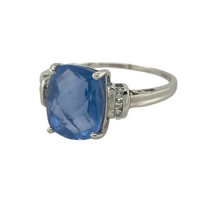 Add vibrant colour and elegant sparkle to your jewellery collection with this pre-owned 9ct white gold blue stone and cubic zirconia ring, featuring a striking gemstone design with sophisticated statement appeal—perfect for special occasions, gifting, or refined everyday wear.

Design: The ring showcases a stunning elongated cushion-cut blue stone measuring approximately 11mm by 8mm, creating a bold and eye-catching focal point.