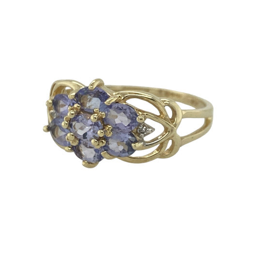 Add captivating colour and timeless sparkle to your jewellery collection with this pre-owned 9ct yellow gold diamond and tanzanite cluster ring, featuring an elegant gemstone design with sophisticated everyday appeal—perfect for special occasions, gifting, or refined daily wear.

Design: The ring showcases a beautiful tanzanite and diamond cluster measuring approximately 10mm high at the front, creating a striking focal point with vibrant violet-blue tones and exceptional sparkle.