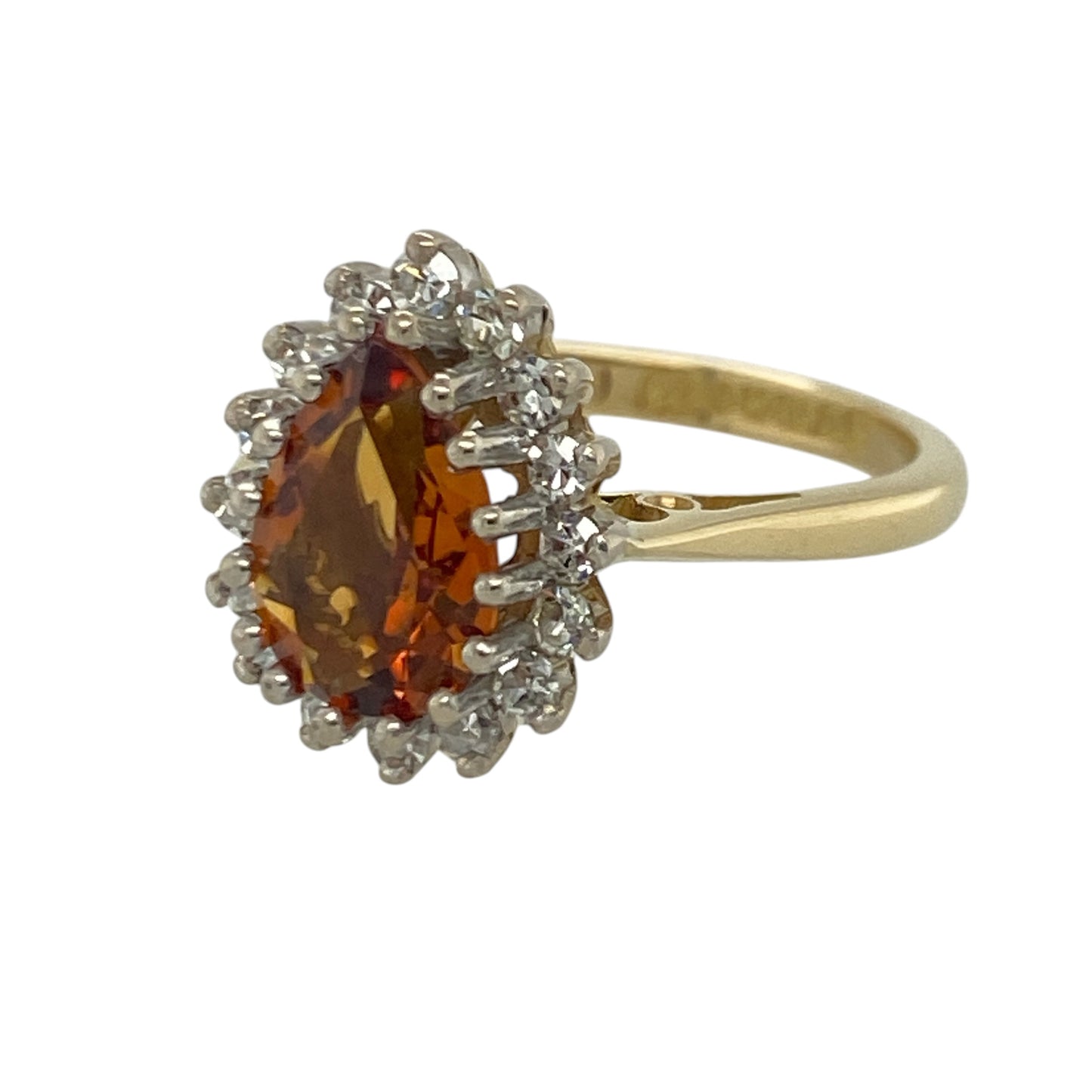 Add vibrant colour and luxurious sparkle to your jewellery collection with this pre-owned 18ct yellow gold diamond and orange tourmaline cluster ring, featuring a striking gemstone design with elegant statement appeal—perfect for special occasions, gifting, or sophisticated everyday wear.

Design: The ring showcases a stunning teardrop-shaped orange tourmaline measuring approximately 10mm by 7mm, creating a bold and eye-catching focal point.