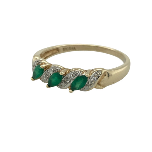 Add vibrant colour and timeless elegance to your jewellery collection with this pre-owned 9ct yellow gold diamond and emerald band ring, featuring a beautifully balanced design with refined everyday appeal—perfect for special occasions, gifting, or sophisticated daily wear.

Design: The ring features an attractive gemstone-set band measuring approximately 5mm wide at the front, showcasing three marquise-cut emeralds, each measuring approximately 4mm by 2mm.