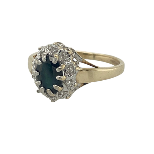 Add timeless elegance and vibrant colour to your jewellery collection with this pre-owned 9ct yellow gold diamond and sapphire cluster ring, featuring a classic gemstone design with refined everyday appeal—perfect for special occasions, gifting, or sophisticated daily wear.

Design: The ring showcases a beautiful oval sapphire measuring approximately 7mm by 5mm, creating a striking focal point with its rich blue colour.