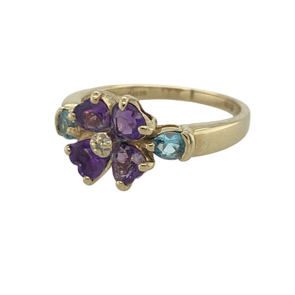 Add a vibrant touch of colour and sparkle to your jewellery collection with this pre-owned 9ct yellow gold diamond, amethyst and blue topaz flower ring, featuring a charming floral design with elegant everyday appeal—perfect for special occasions, gifting, or refined daily wear.

Design: The ring showcases a beautiful flower-inspired cluster design measuring approximately 9mm high at the front.