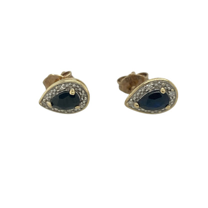 Add timeless elegance and vibrant colour to your jewellery collection with these pre-owned 9ct yellow gold diamond and sapphire cluster stud earrings, featuring a graceful gemstone design with sophisticated everyday appeal—perfect for special occasions, gifting, or refined daily wear.

Design: The earrings showcase beautiful teardrop-shaped sapphire gemstones, each measuring approximately 8mm by 6mm, surrounded by sparkling diamond accents in an elegant cluster setting