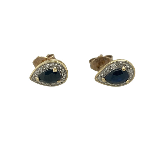 Add timeless elegance and vibrant colour to your jewellery collection with these pre-owned 9ct yellow gold diamond and sapphire cluster stud earrings, featuring a graceful gemstone design with sophisticated everyday appeal—perfect for special occasions, gifting, or refined daily wear.

Design: The earrings showcase beautiful teardrop-shaped sapphire gemstones, each measuring approximately 8mm by 6mm, surrounded by sparkling diamond accents in an elegant cluster setting