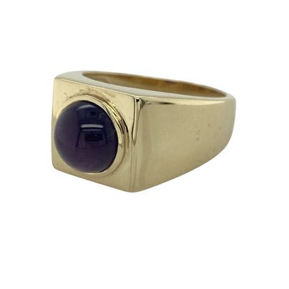 Make a bold statement with this pre-owned 9ct yellow gold cabochon purple stone signet ring, featuring a substantial design with classic styling and distinctive character—perfect for collectors, special occasions, or those who appreciate unique vintage-inspired jewellery.

Design: The ring showcases a striking square signet-style top set with a polished cabochon purple stone measuring approximately 9mm in diameter.