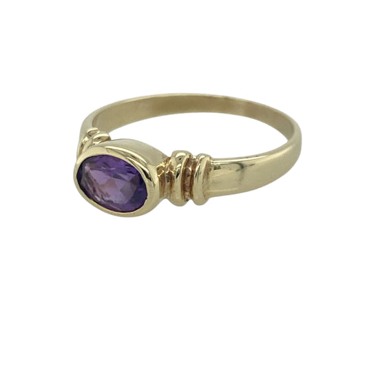 Add a touch of vibrant colour and timeless elegance to your jewellery collection with this pre-owned 9ct yellow gold amethyst ring, featuring a classic gemstone design with refined everyday appeal—perfect for gifting, special occasions, or sophisticated daily wear.

Design: The ring showcases a beautiful oval-cut amethyst measuring approximately 7mm by 5mm, creating a striking focal point with its rich purple hue and elegant proportions.