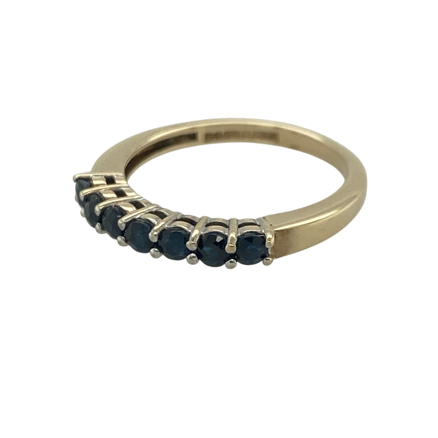 Add timeless elegance and vibrant colour to your jewellery collection with this pre-owned 9ct yellow gold sapphire band ring, featuring a classic gemstone design with refined everyday appeal—perfect for special occasions, gifting, or sophisticated daily wear.

Design: The ring showcases a beautiful arrangement of round sapphires set across the band, each measuring approximately 2.5mm in diameter.