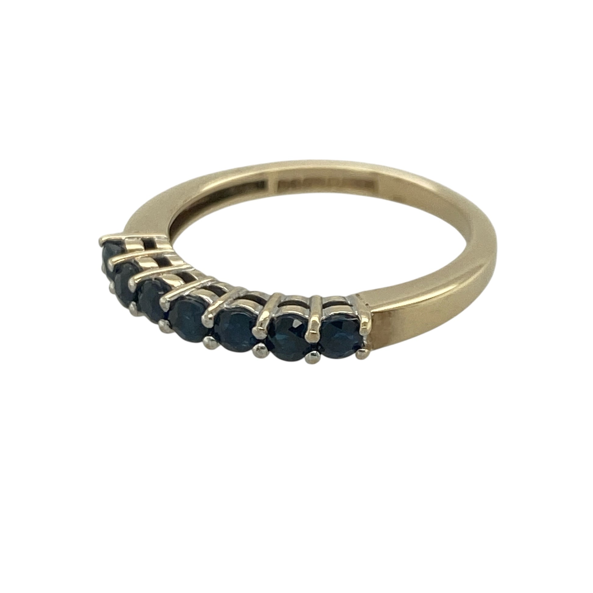 Add timeless elegance and vibrant colour to your jewellery collection with this pre-owned 9ct yellow gold sapphire band ring, featuring a classic gemstone design with refined everyday appeal—perfect for special occasions, gifting, or sophisticated daily wear.

Design: The ring showcases a beautiful arrangement of round sapphires set across the band, each measuring approximately 2.5mm in diameter.