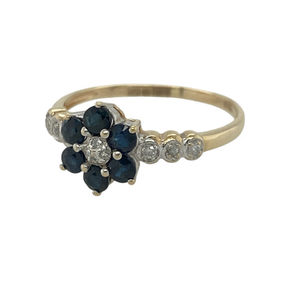Add timeless elegance and vibrant colour to your jewellery collection with this pre-owned 9ct yellow gold diamond and sapphire flower cluster ring, featuring a charming floral design with refined everyday appeal—perfect for special occasions, gifting, or sophisticated daily wear.

Design: The ring showcases a beautiful flower cluster design measuring approximately 9mm high at the front.