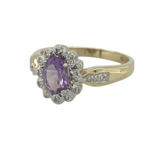 Add a touch of vibrant colour and timeless elegance to your jewellery collection with this pre-owned 9ct yellow gold diamond and amethyst cluster ring, featuring a classic gemstone design with refined everyday appeal—perfect for special occasions, gifting, or sophisticated daily wear.

Design: The ring showcases a beautiful oval amethyst measuring approximately 7mm by 5mm, creating a striking focal point with its rich purple hue.