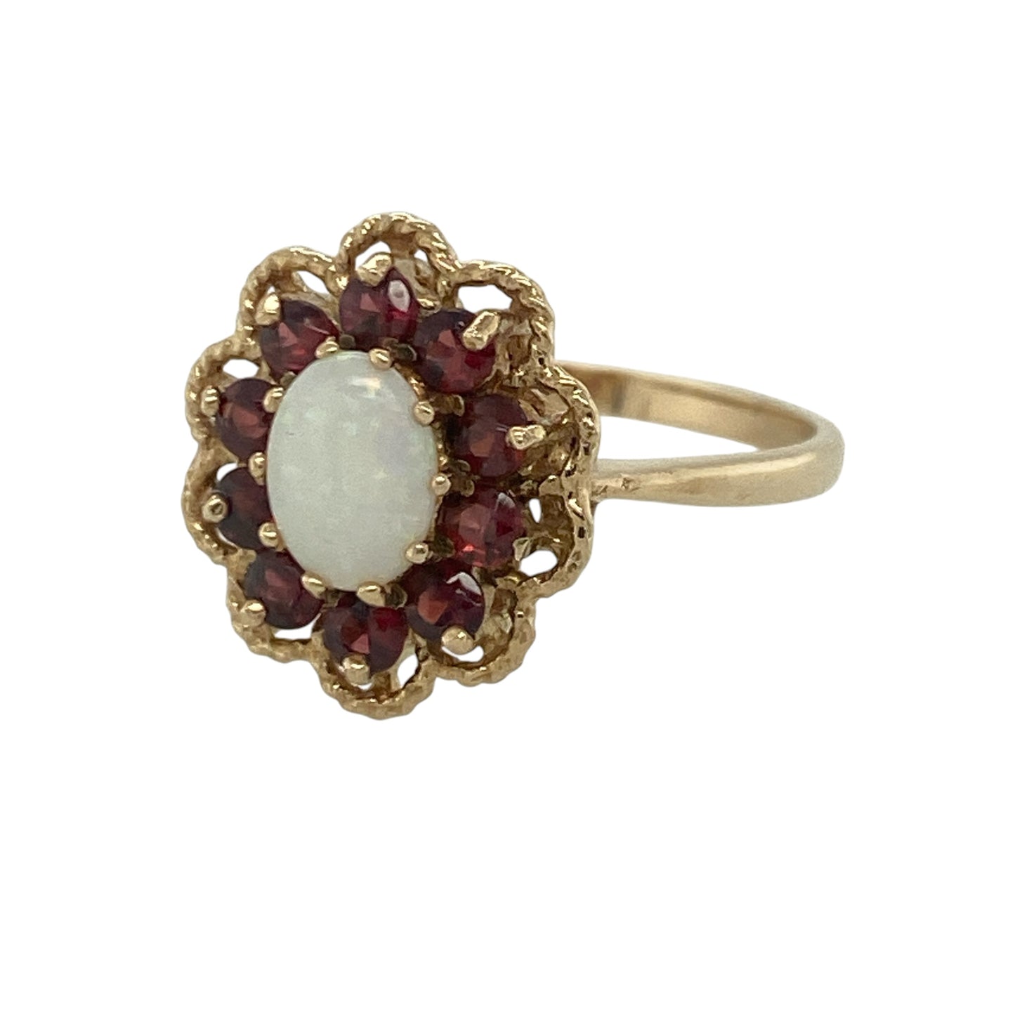 Add a touch of vibrant colour and timeless elegance to your jewellery collection with this pre-owned 9ct yellow gold garnet and opalique cluster ring, featuring a beautifully contrasting gemstone design with refined everyday appeal—perfect for special occasions, gifting, or sophisticated daily wear.

Design: The ring showcases a captivating oval opalique centre stone measuring approximately 7mm by 5mm, displaying soft iridescent flashes of colour.