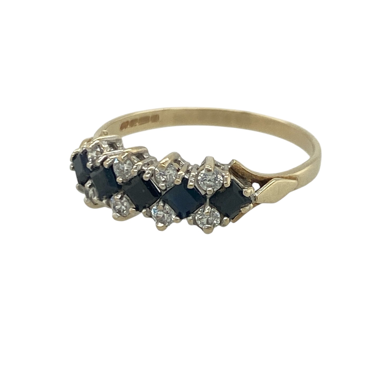 Add timeless elegance and vibrant sparkle to your jewellery collection with this pre-owned 9ct yellow gold sapphire and cubic zirconia cluster band ring, featuring a classic gemstone design with refined everyday appeal—perfect for special occasions, gifting, or sophisticated daily wear.

Design: The ring features an attractive cluster-style band measuring approximately 6mm wide at the front, showcasing a beautiful combination of rich blue sapphires and sparkling cubic zirconia stones.