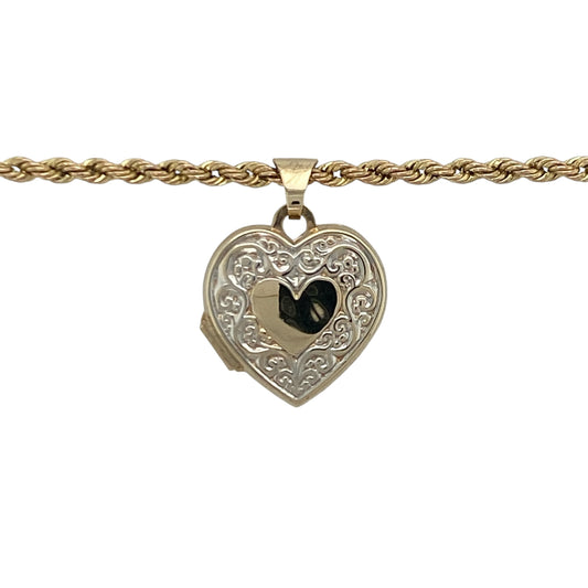 Add a touch of romance and timeless sentiment to your jewellery collection with this pre-owned 9ct yellow and white gold patterned heart locket necklace, featuring a beautifully detailed design with meaningful everyday appeal—perfect for gifting, keepsakes, or treasured personal wear.

Design: The necklace features an elegant heart-shaped locket adorned with attractive patterned detailing, creating a charming and eye-catching appearance.